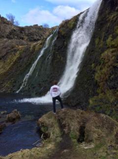 Taylor admiring one of Gjáin's many waterfalls.